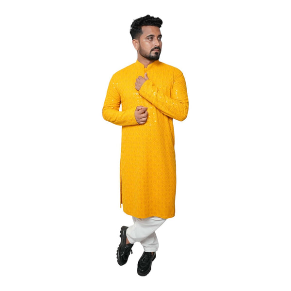 Man wearing a vibrant yellow kurta, perfect for festive occasions, showcasing modern and traditional styles.