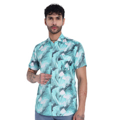 Model wearing a turquoise patterned short-sleeve shirt, showcasing a stylish casual look.